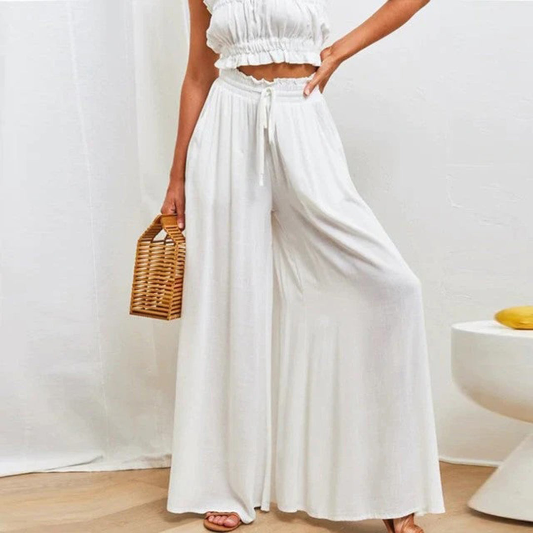 skirts : Jade – Pantalon palazzo ample à jambes larges et taille haute in Blanc van Seroa