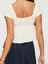 top blouses : Elodie - Top court Smocké à Manches courtes et nœud Ajustable in van Seroa